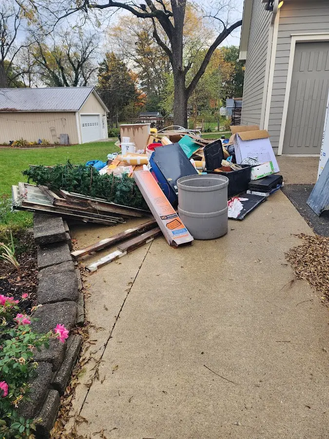 Dumpster being loaded with debris for Roofing Dumpster Rental in Jeanerette